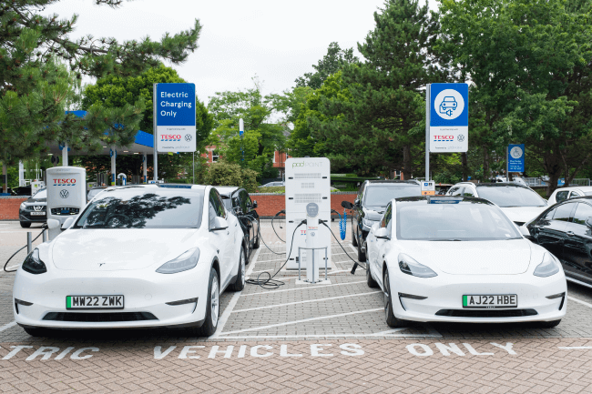 Electric car charging station, Tesla cars in a Tesco car park UK