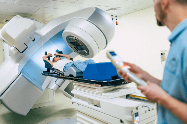 A woman receiving radiation therapy for cancer at a modern medical clinic or hospital equipped with a linear accelerator, while a team of professional doctors works.