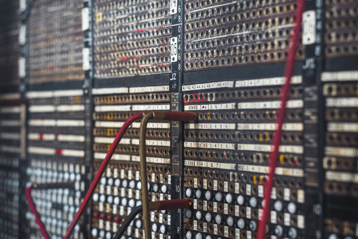 Image of a vintage manual telephone exchange switchboard with selective focus
