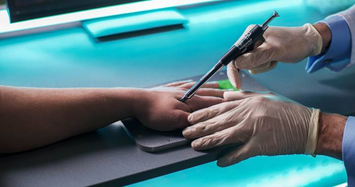 Scientist in gloves injecting RFID chip into hand of crop client in modern laboratory.