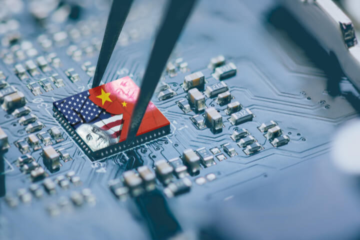 Flag of the USA and China displayed on a microchip, either a CPU or GPU, mounted on a motherboard.