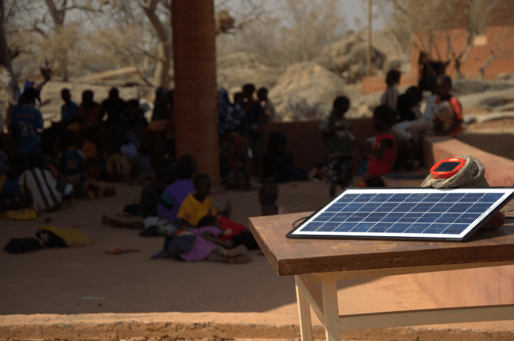 Operndorf Schlingensief small solar cell panel demonstration in front of students, Ouagadougou, Burkina Faso - January 10th, 2014