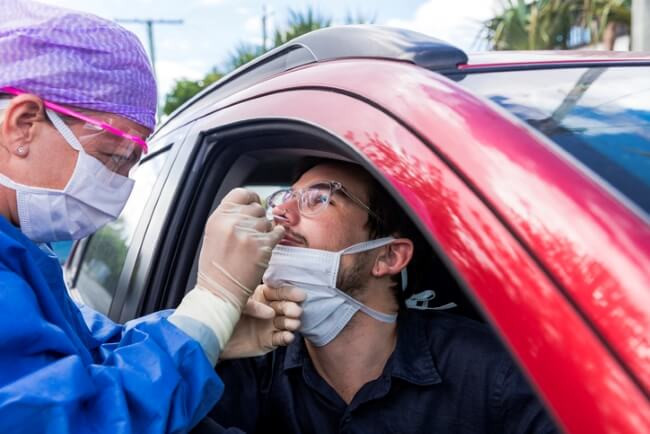 doctor taking a coronavirus nasal swab from a patient