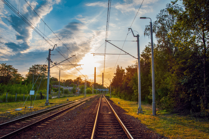 At sunset, in Siemianowice lskie, Poland, there is a railway line running through the city.