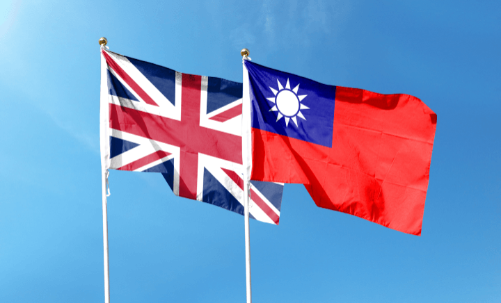 British and Taiwanese flags flutter against a cloudy backdrop.