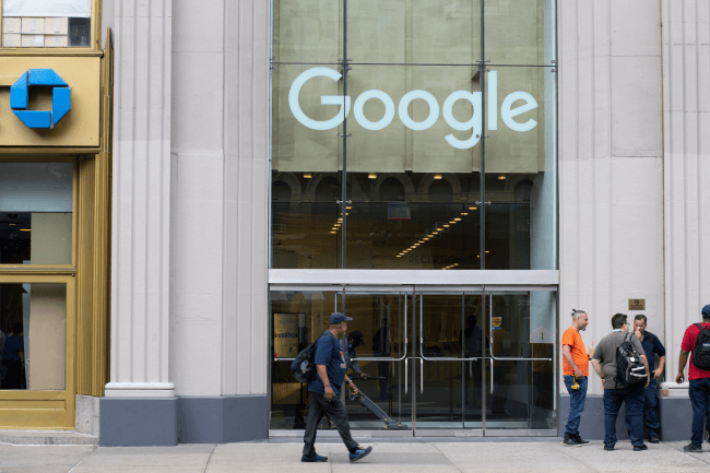 A man walks past the Google office, the Chelsea campus, in New York City. Google LLC is a global technology company headquartered in Mountain View, California.